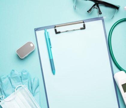 Medical supplies pulse oximeter and electronic thermometer and other medical supplies on a blue back